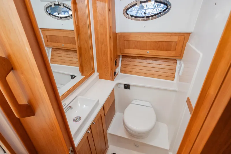 Slide: The Image of Luxurious bathroom in 2026 Back Cove 34O yacht with wooden cabinetry and modern fixtures. - 14