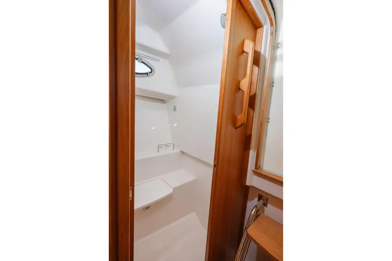 Slide: The Image of 2026 Back Cove 34O yacht interior with wooden door and compact bathroom. - 15
