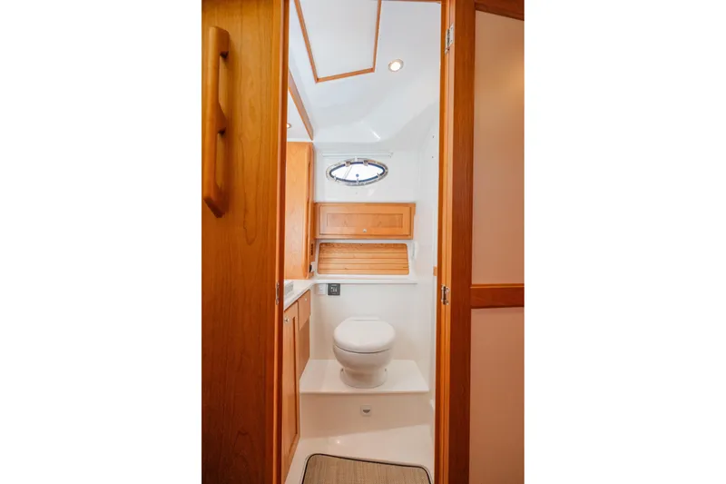 Slide: The Image of 2026 Back Cove 34O yacht bathroom with wooden cabinetry and modern fixtures. - 16