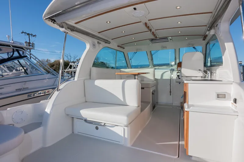 Slide: The Image of 2026 Back Cove 34O yacht interior with white seating and modern amenities. - 6
