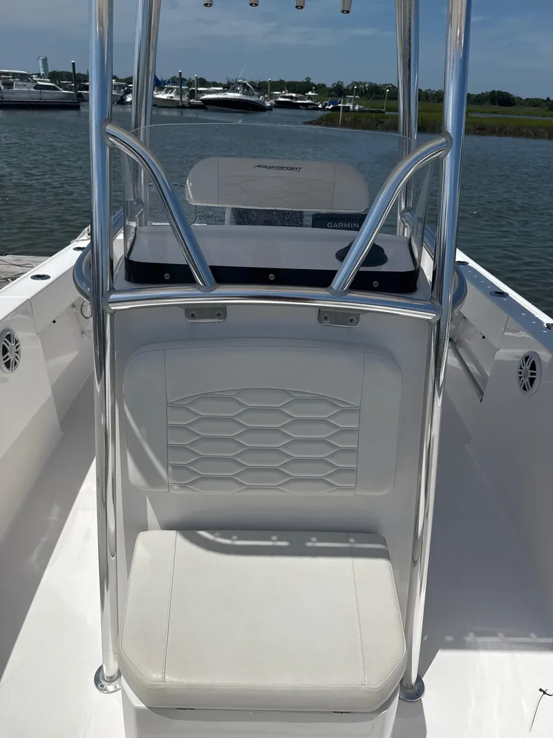 Slide: The Image of 2024 Aquasport 2200 Center Console boat interior with seating and console view. - 5