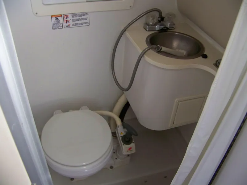 Slide: The Image of 1996 Crownline 250 CR boat bathroom with toilet and sink. - 11
