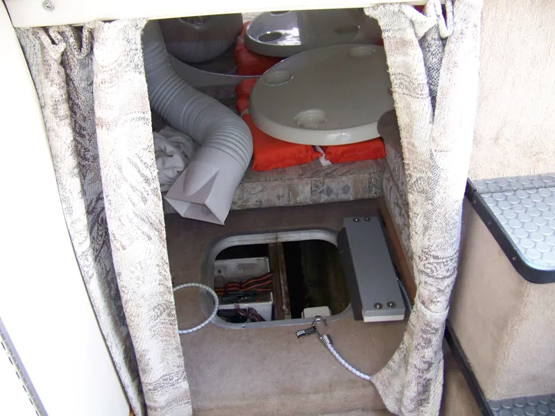 Slide: The Image of Interior of a 1996 Crownline 250 CR boat showing storage and seating area. - 13