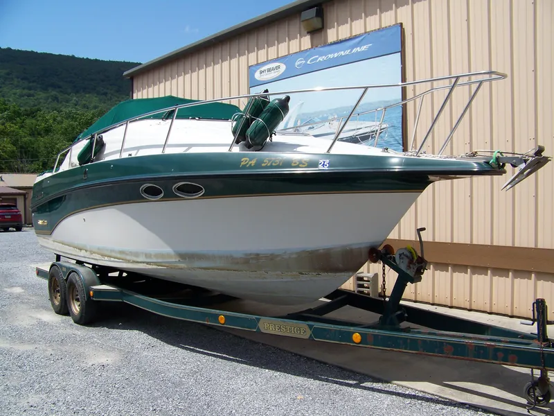 Slide: The Image of 1996 Crownline 250 CR boat on trailer, parked outside a building. - 3