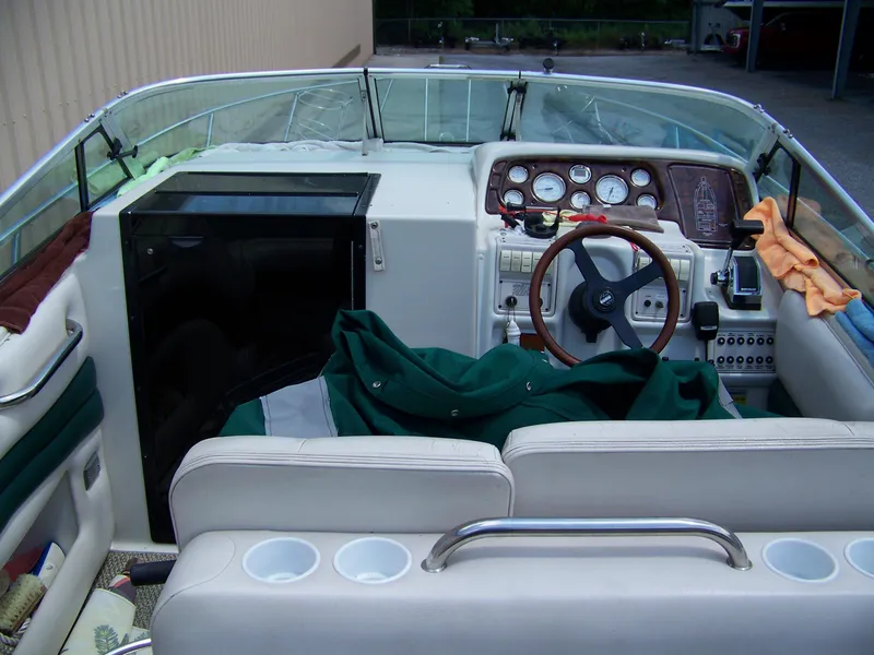 Slide: The Image of 1996 Crownline 250 CR boat interior with steering wheel, dashboard, and seating area. - 5