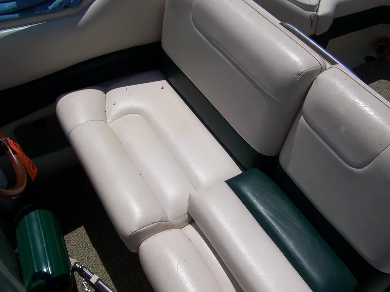 Slide: The Image of 1996 Crownline 250 CR boat interior with white and green cushioned seating. - 8