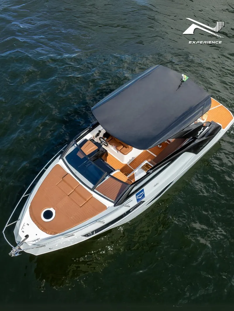Slide: The Image of 2025 NX Boats NX290 Exclusive on water, featuring sleek design and spacious deck. - 4