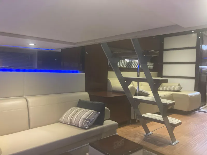 Slide: The Image of Luxurious interior of 2015 Sea Ray 450 Sundancer yacht with modern seating and ambient lighting. - 11
