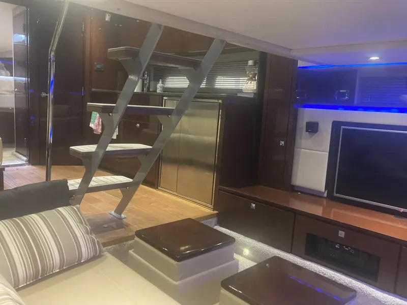 Slide: The Image of Luxurious interior of 2015 Sea Ray 450 Sundancer yacht with modern staircase and entertainment area. - 12