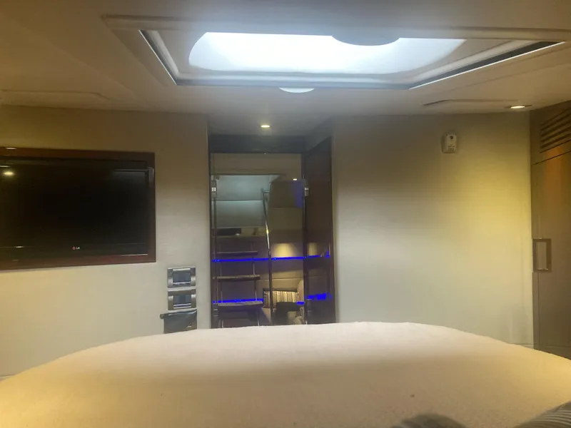 Slide: The Image of Interior of 2015 Sea Ray 450 Sundancer yacht with TV and modern lighting. - 14