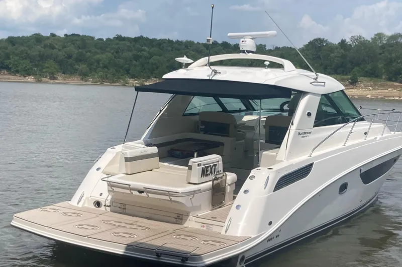 Slide: The Image of 2015 Sea Ray 450 Sundancer yacht on calm water, featuring spacious deck and sleek design. - 3