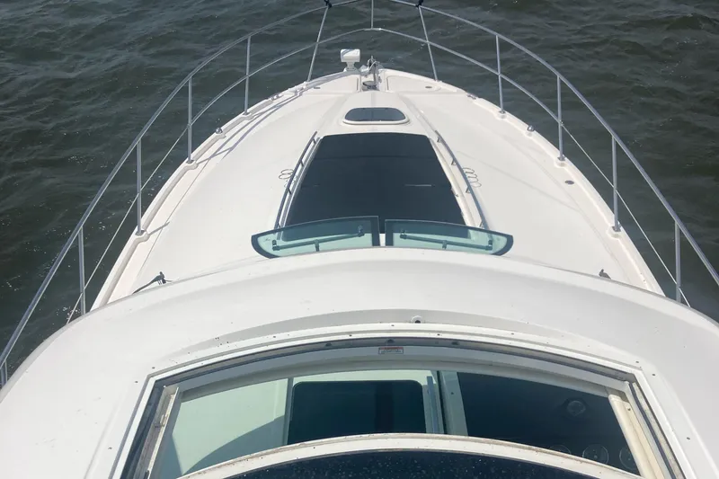 Slide: The Image of 2015 Sea Ray 450 Sundancer yacht bow view on open water. - 5