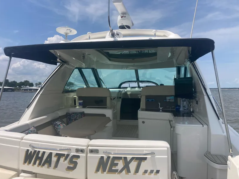 Slide: The Image of 2015 Sea Ray 450 Sundancer yacht with open deck, lake view, and "What's Next" text. - 8