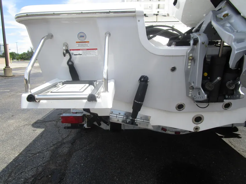 Slide: The Image of 2025 Sea Pro 230 DLX BAY boat stern with swim platform and hydraulic components. - 12