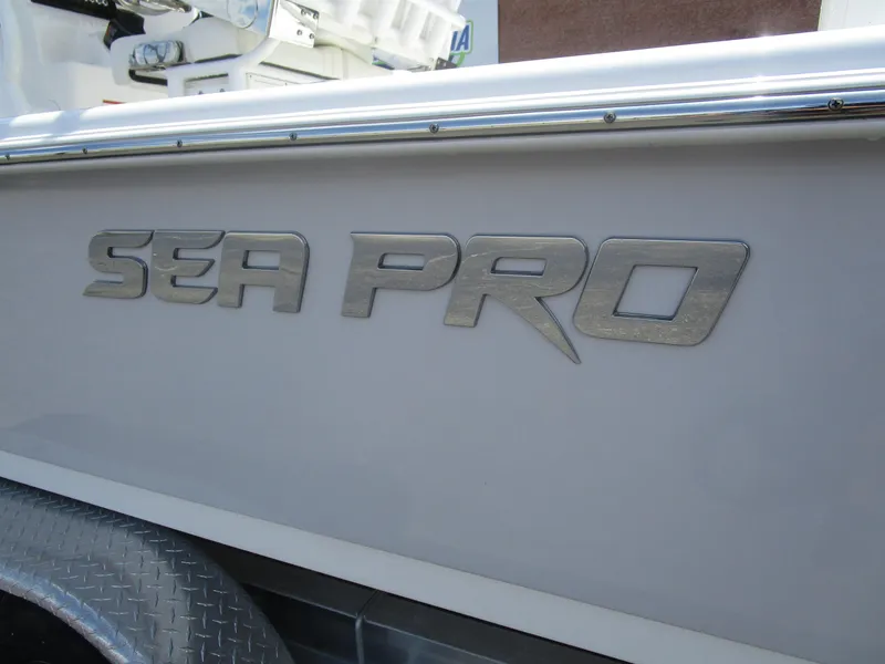 Slide: The Image of 2025 Sea Pro 230 DLX BAY boat logo on side panel. - 2