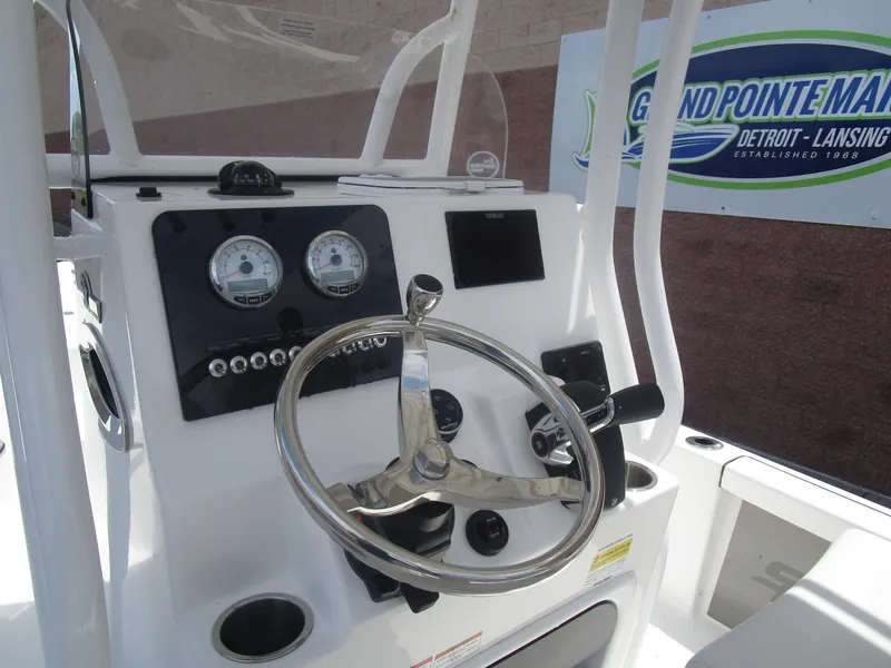 Slide: The Image of 2025 Sea Pro 230 DLX BAY boat console with steering wheel and gauges. - 5