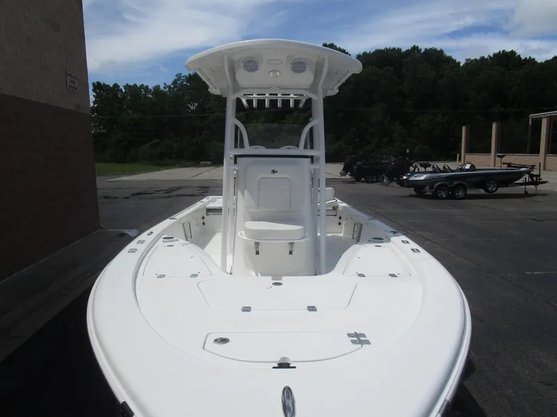 Slide: The Image of 2025 Sea Pro 230 DLX BAY boat with T-top, parked outdoors on a sunny day. - 9