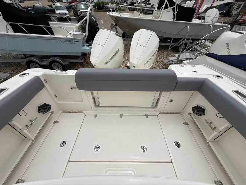 Slide: The Image of 2026 Boston Whaler 250 Outrage boat interior with Mercury engines, spacious deck, and seating. - 10