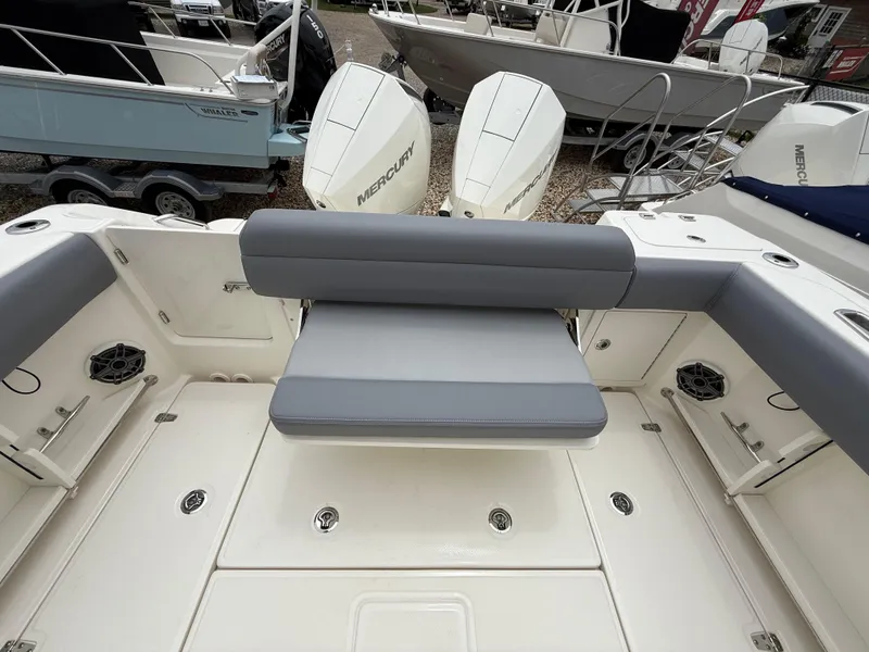 Slide: The Image of 2026 Boston Whaler 250 Outrage boat interior with gray seating and Mercury engines. - 12
