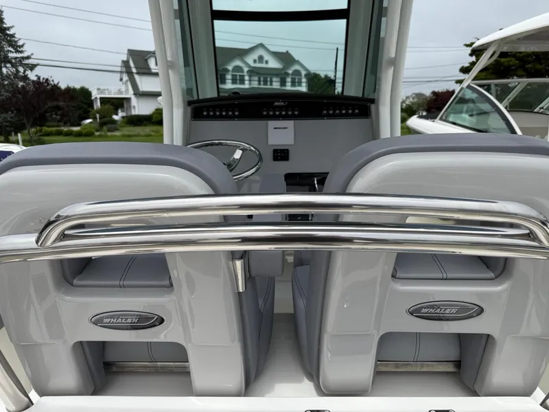 Slide: The Image of 2026 Boston Whaler 250 Outrage boat interior with sleek seating and modern dashboard. - 16