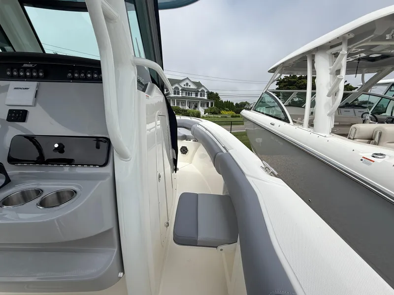 Slide: The Image of 2026 Boston Whaler 250 Outrage boat interior with seating and control panel. - 26