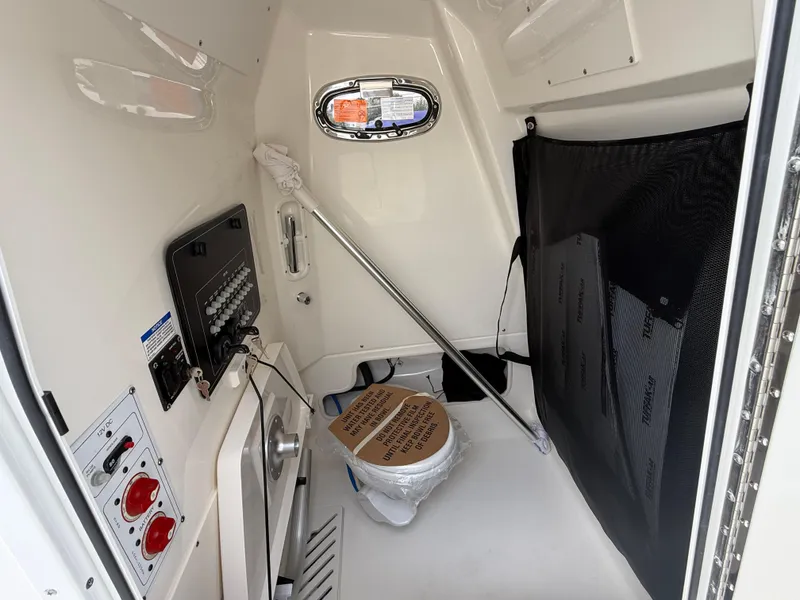 Slide: The Image of Interior of 2026 Boston Whaler 250 Outrage boat, featuring control panel and storage area. - 27