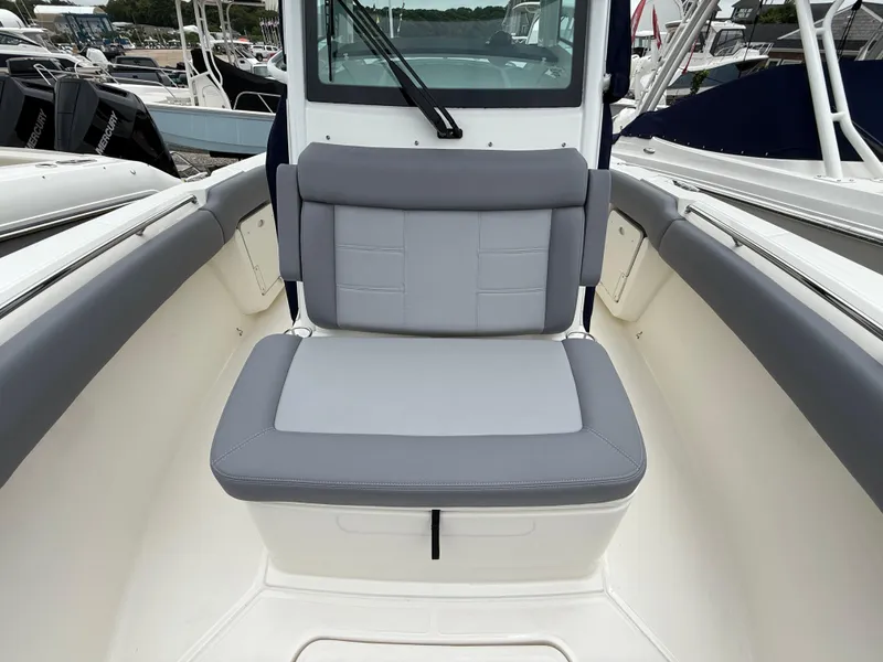 Slide: The Image of 2026 Boston Whaler 250 Outrage boat interior with gray cushioned seating. - 28