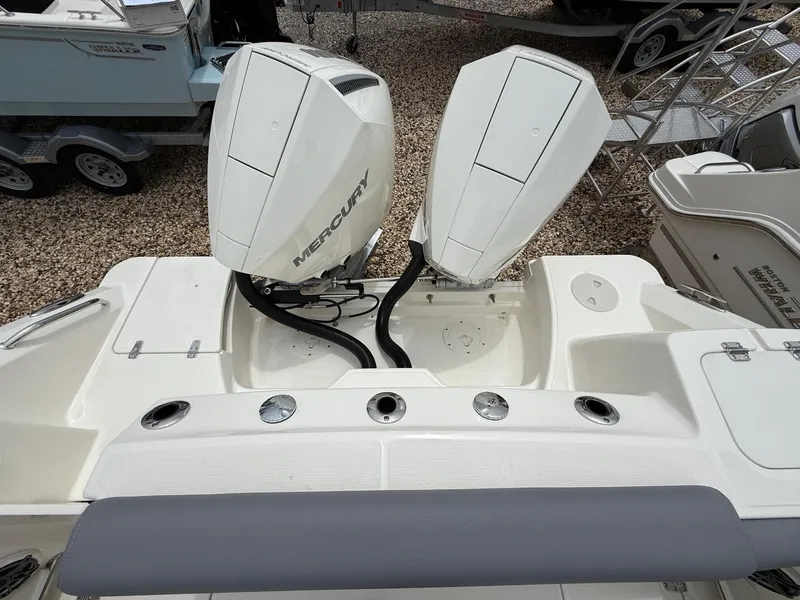 Slide: The Image of 2026 Boston Whaler 250 Outrage with dual Mercury outboard engines, rear view. - 8