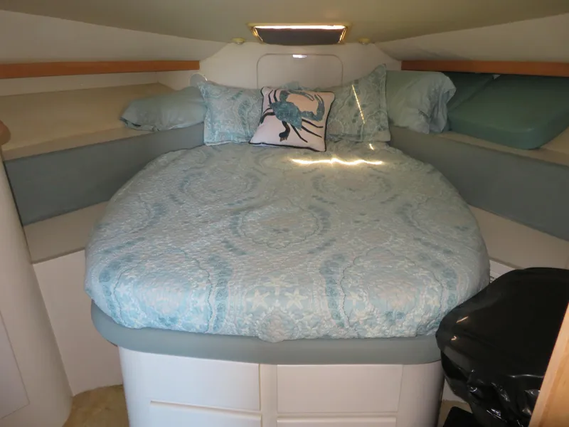 Slide: The Image of Cozy bedroom in 1994 Carver 380 Santego yacht with blue bedding and crab-themed pillow. - 10