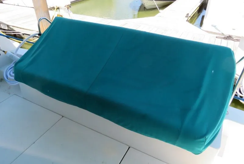 Slide: The Image of Green-covered seat on 1994 Carver 380 Santego boat deck at marina. - 3
