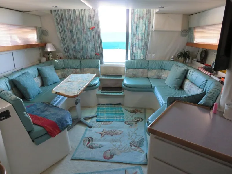 Slide: The Image of Luxurious interior of a 1994 Carver 380 Santego yacht with cozy seating and ocean view. - 6