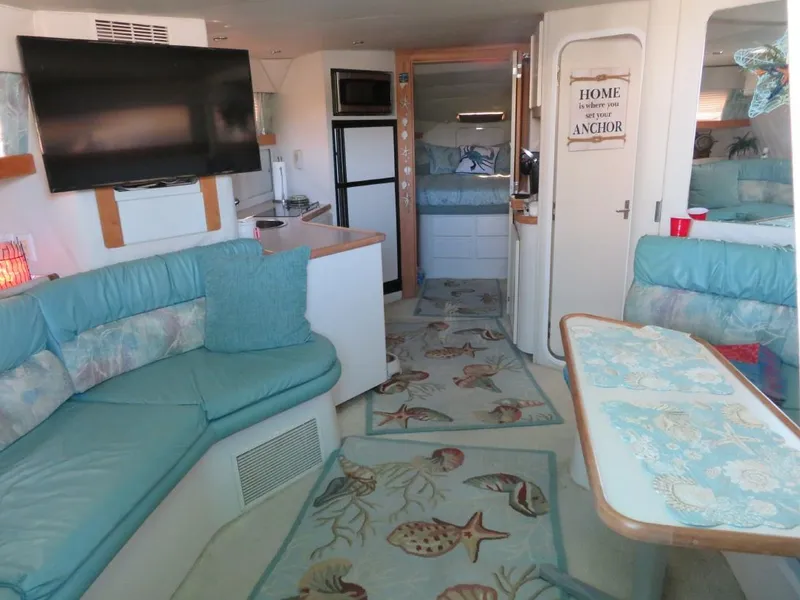 Slide: The Image of Interior of a 1994 Carver 380 Santego yacht with cozy seating and nautical decor. - 7