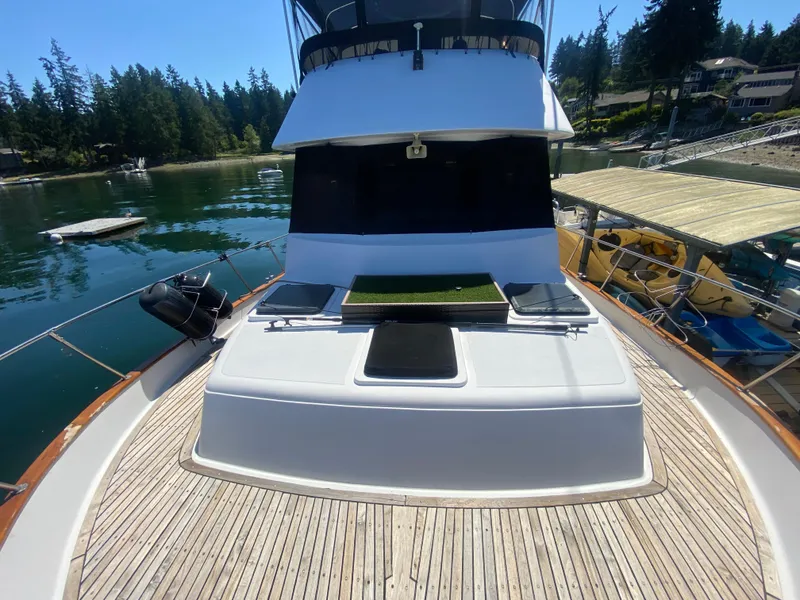 Slide: The Image of 1982 C & L Sea Ranger yacht docked in a serene marina setting. - 13