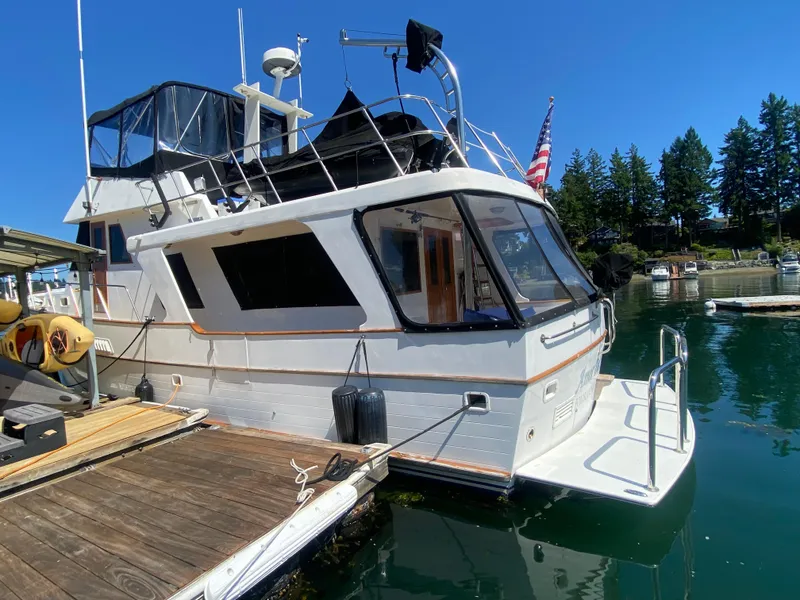 Slide: The Image of 1982 C & L Sea Ranger yacht docked at a marina, under clear blue skies. - 17