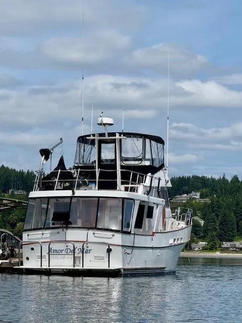 Slide: The Image of 1982 C & L Sea Ranger boat docked on calm water under a cloudy sky. - 18