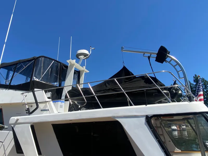 Slide: The Image of 1982 C & L Sea Ranger boat with radar and canopy, under clear blue sky. - 19