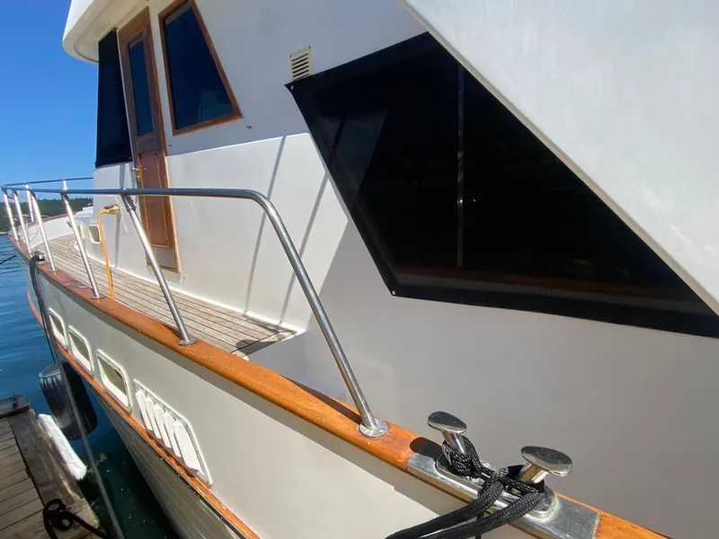 Slide: The Image of 1982 C & L Sea Ranger yacht docked, featuring wooden railings and sleek design. - 21