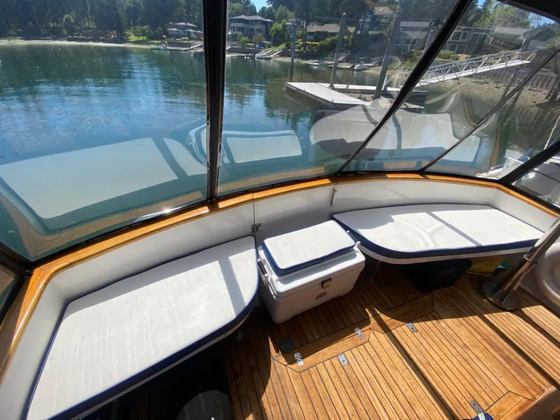 Slide: The Image of 1982 C & L Sea Ranger boat interior with cushioned seating and wooden flooring. - 26