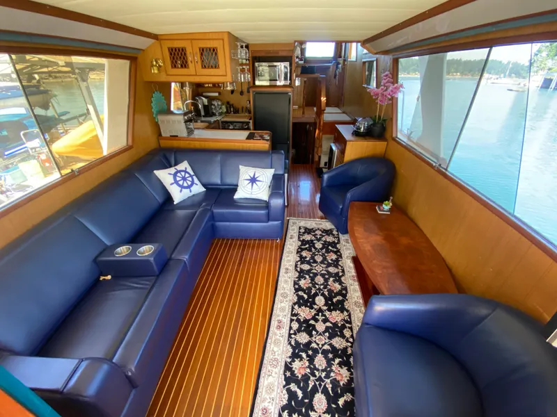 Slide: The Image of Luxurious 1982 C & L Sea Ranger yacht interior with blue seating and elegant decor. - 31