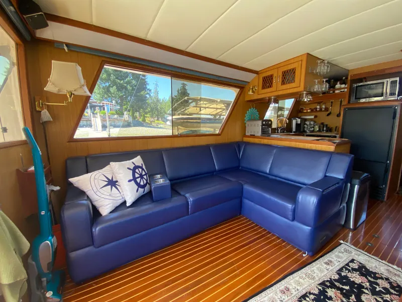Slide: The Image of Interior of 1982 C & L Sea Ranger with blue sofa and kitchenette. - 32