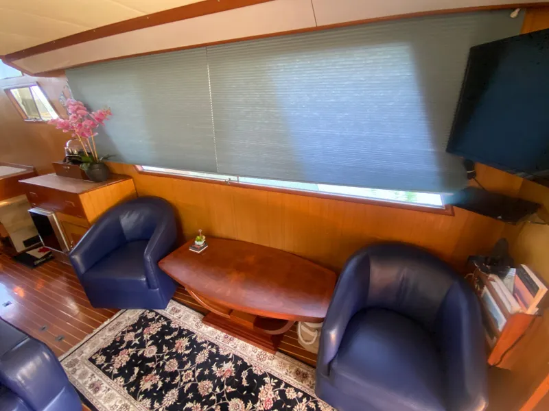 Slide: The Image of Interior of 1982 C & L Sea Ranger yacht with blue chairs and wooden table. - 35