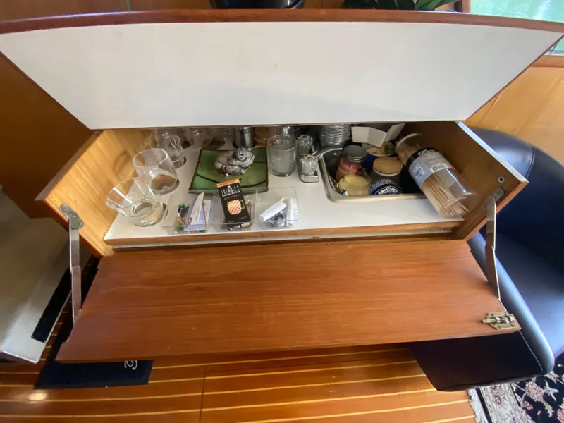 Slide: The Image of 1982 C & L Sea Ranger bar cabinet with glasses, snacks, and beverages. - 39