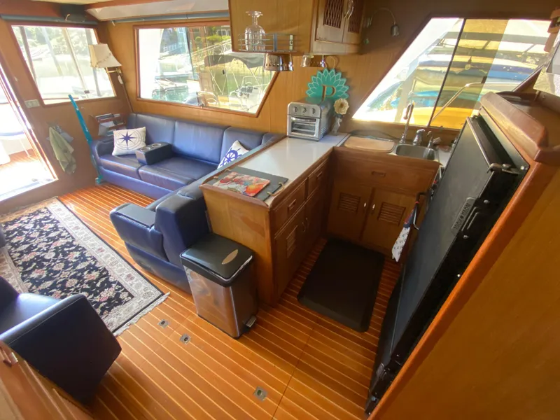 Slide: The Image of Interior of 1982 C & L Sea Ranger yacht with cozy seating and kitchenette. - 40