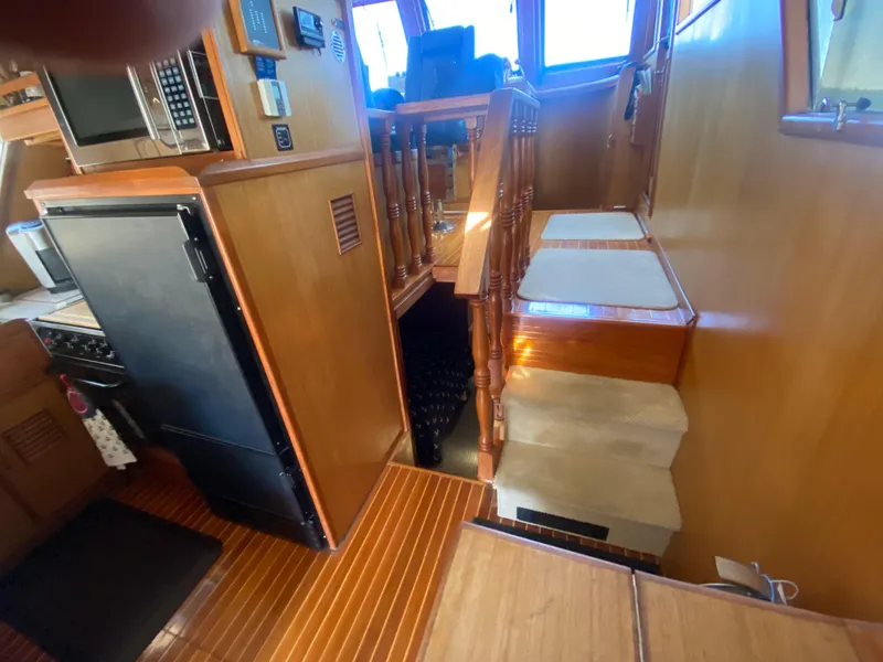 Slide: The Image of Interior of 1982 C & L Sea Ranger yacht with wooden stairs and kitchen area. - 43