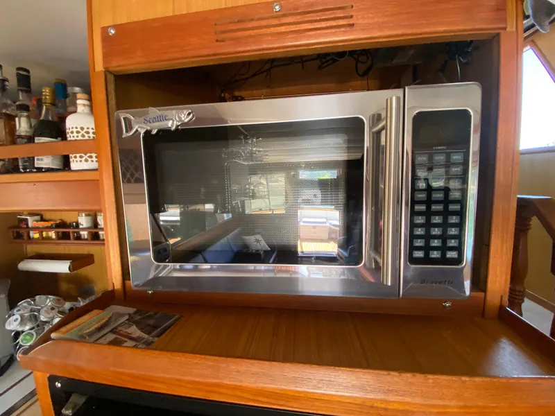 Slide: The Image of Microwave in 1982 C & L Sea Ranger yacht kitchen with wooden cabinetry. - 46