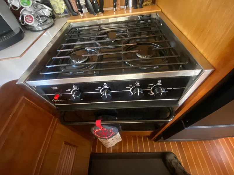 Slide: The Image of Stove in 1982 C & L Sea Ranger boat kitchen with wooden cabinetry. - 49