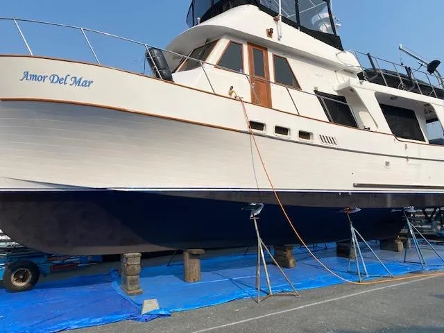 Slide: The Image of 1982 C & L Sea Ranger yacht "Amor Del Mar" on dry dock, blue tarp underneath. - 5