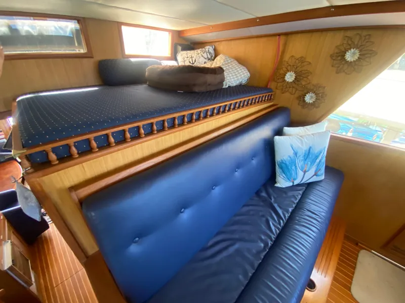 Slide: The Image of Interior of 1982 C & L Sea Ranger with blue seating and decorative pillows. - 51