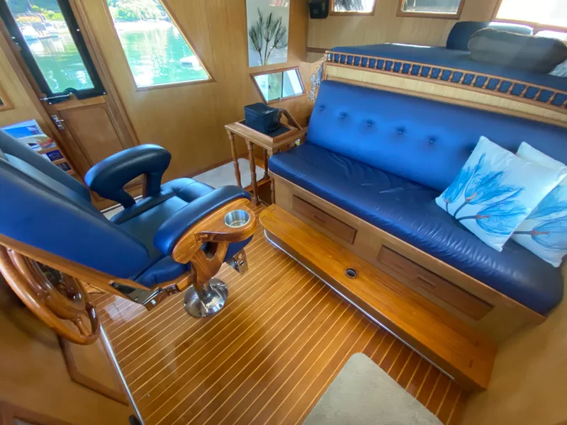 Slide: The Image of Interior of 1982 C & L Sea Ranger yacht with blue seating and wooden accents. - 52