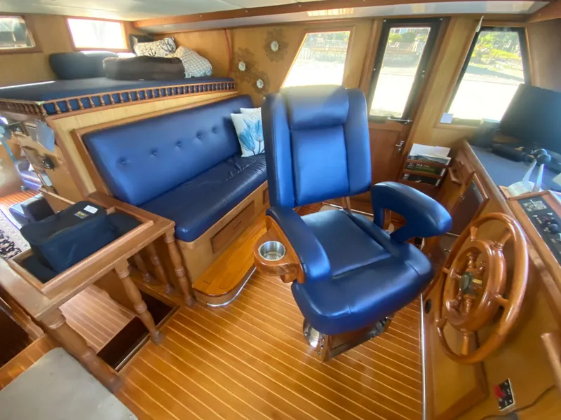 Slide: The Image of Interior of 1982 C & L Sea Ranger yacht with blue seating and wooden accents. - 53